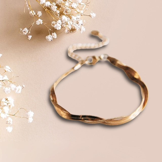 Roestvrijstalen gevlochten slangenarmband - goud - verpakt in organza zakje en luxe cadeauverpakking